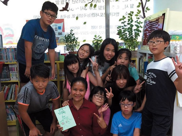 Luda with children at her "English stories"